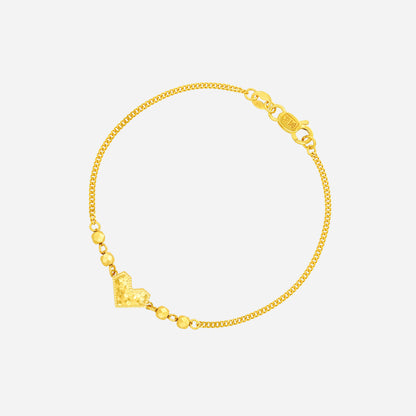 Radiant Heart Bracelet in 22K yellow gold with textured heart centerpiece and gold beads on a fine chain.