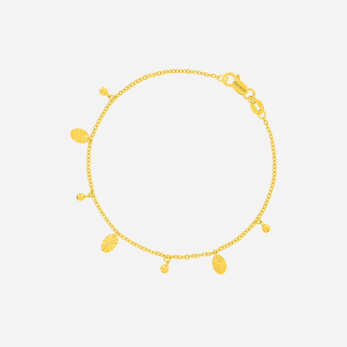 Dainty bracelet in 22K yellow gold with textured oval charms and polished round accents, perfect for layering.