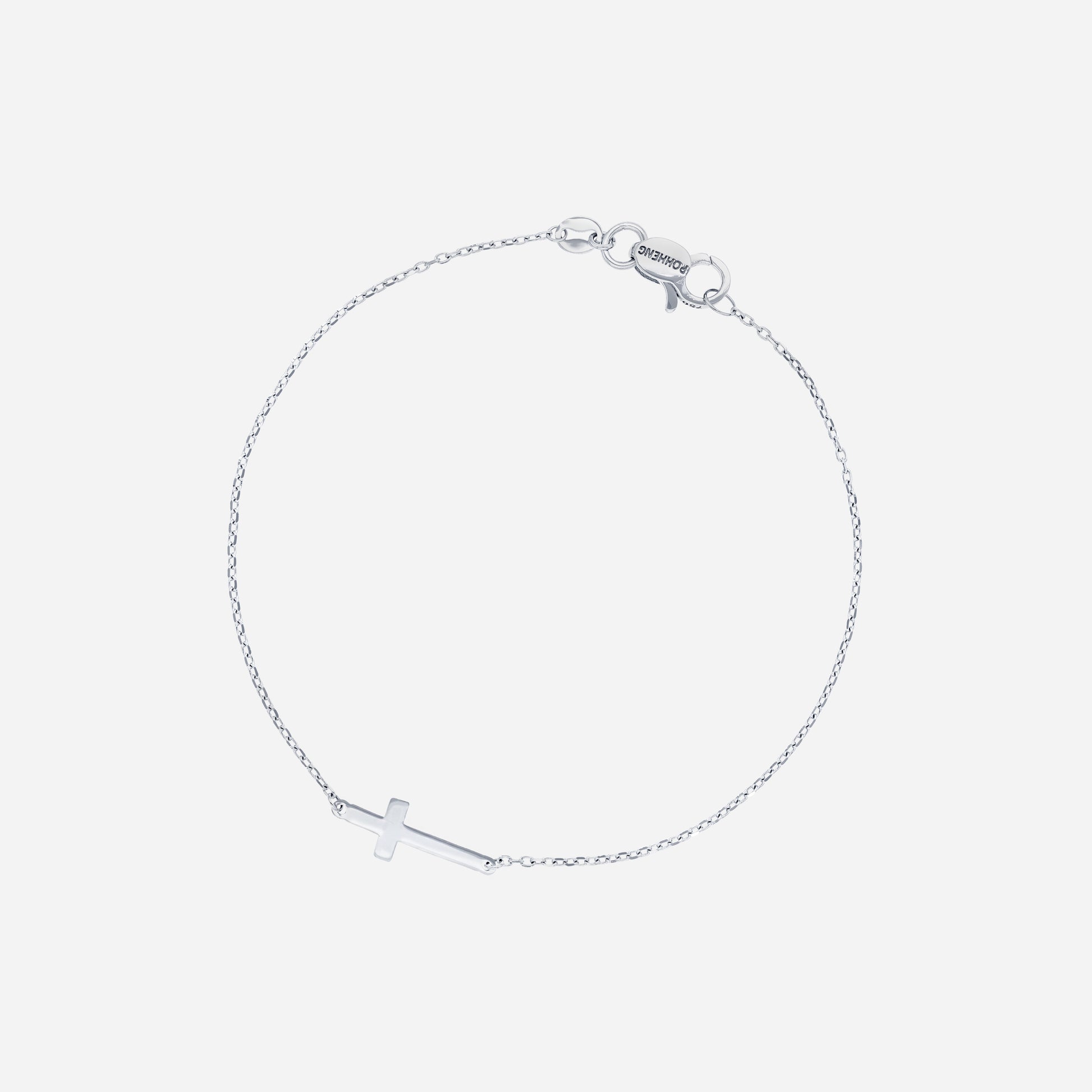 Cross bracelet in 18K white gold with a delicate charm on a fine chain, symbolizing faith and grace.