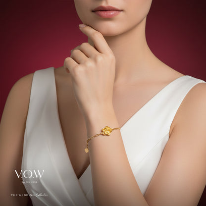 Rose bracelet in 24K yellow gold featuring an intricate rose design, worn on a slender wrist against a soft background.