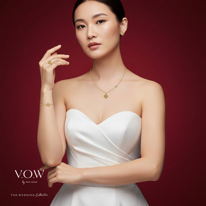 Aurora Bloom Bracelet in 24K Yellow Gold with clover motif and green enamel accents, worn on a model's wrist.