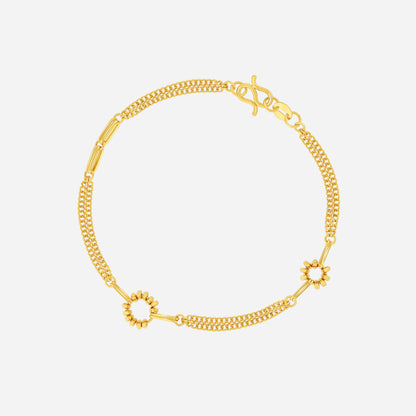 Curve link bracelet in 22K yellow gold with smooth rounded links and circular floral accents.
