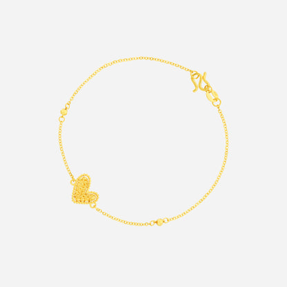 Delicate heart bracelet in 24K yellow gold with charming details and small gold beads. Perfect everyday wear.