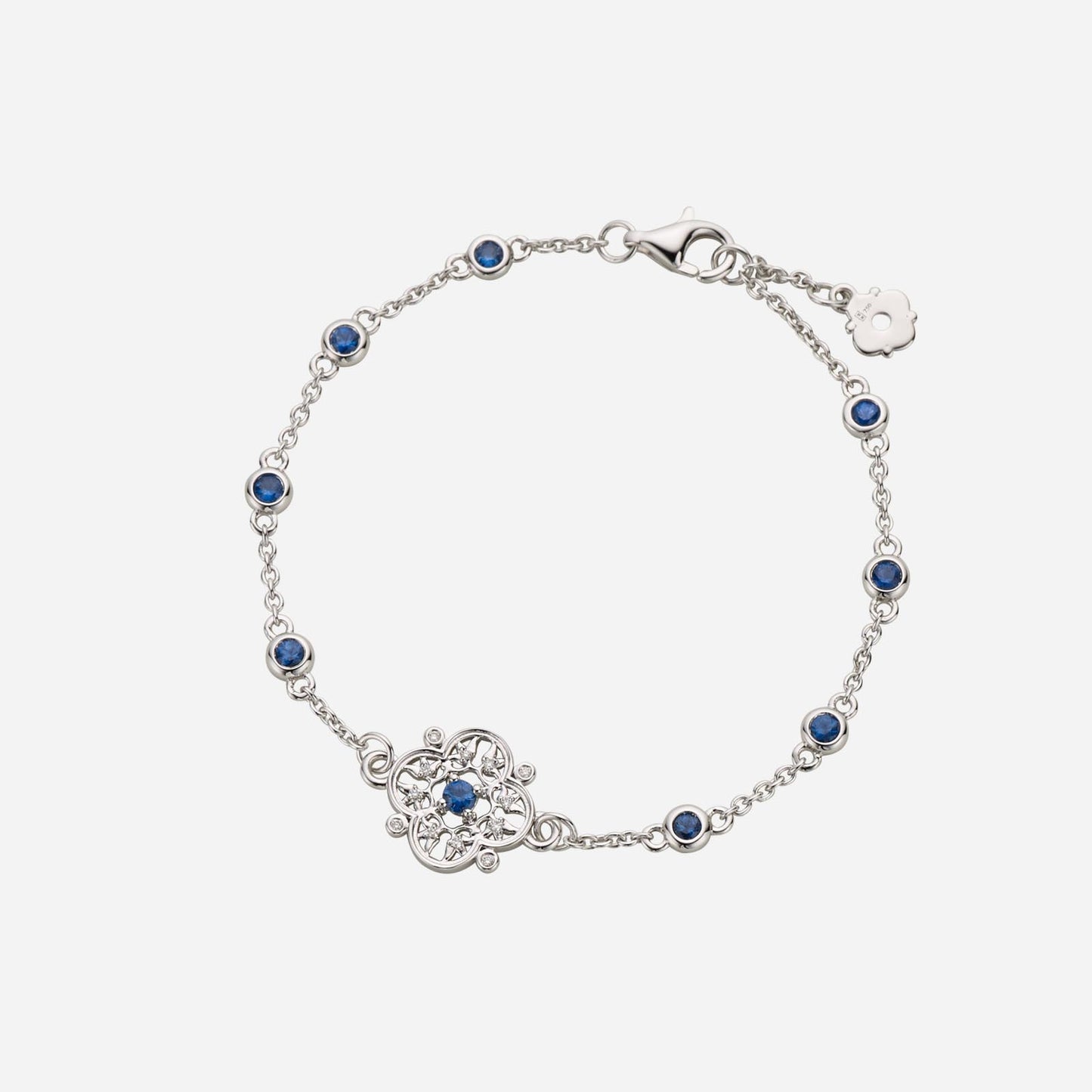legacy floral sapphire diamond bracelet in white gold with blue sapphires and detailed floral design.