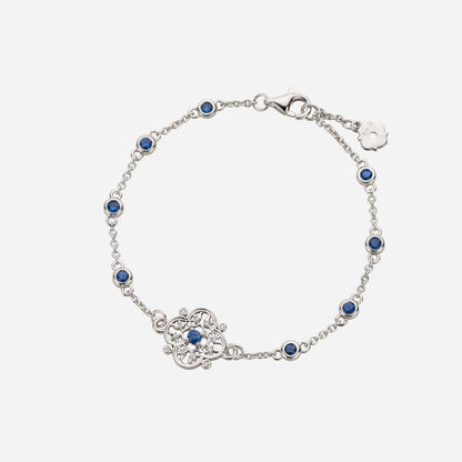 Legacy floral sapphire diamond bracelet in white gold with blue sapphires and detailed floral design.