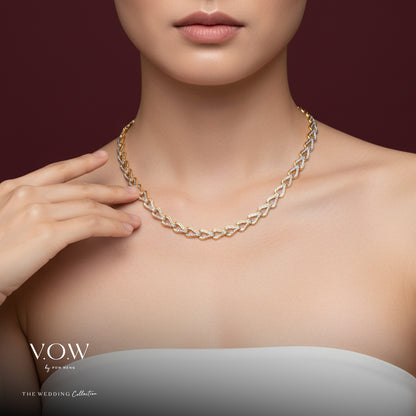 Elegant Omega necklace in 22K yellow and white gold, showcasing a sophisticated heart-shaped link design.