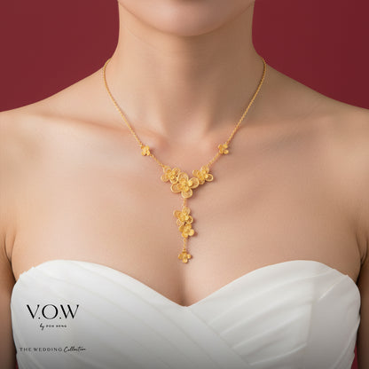 Delicate flower necklace in 24K yellow gold, featuring intricate floral designs and a feminine elegance.