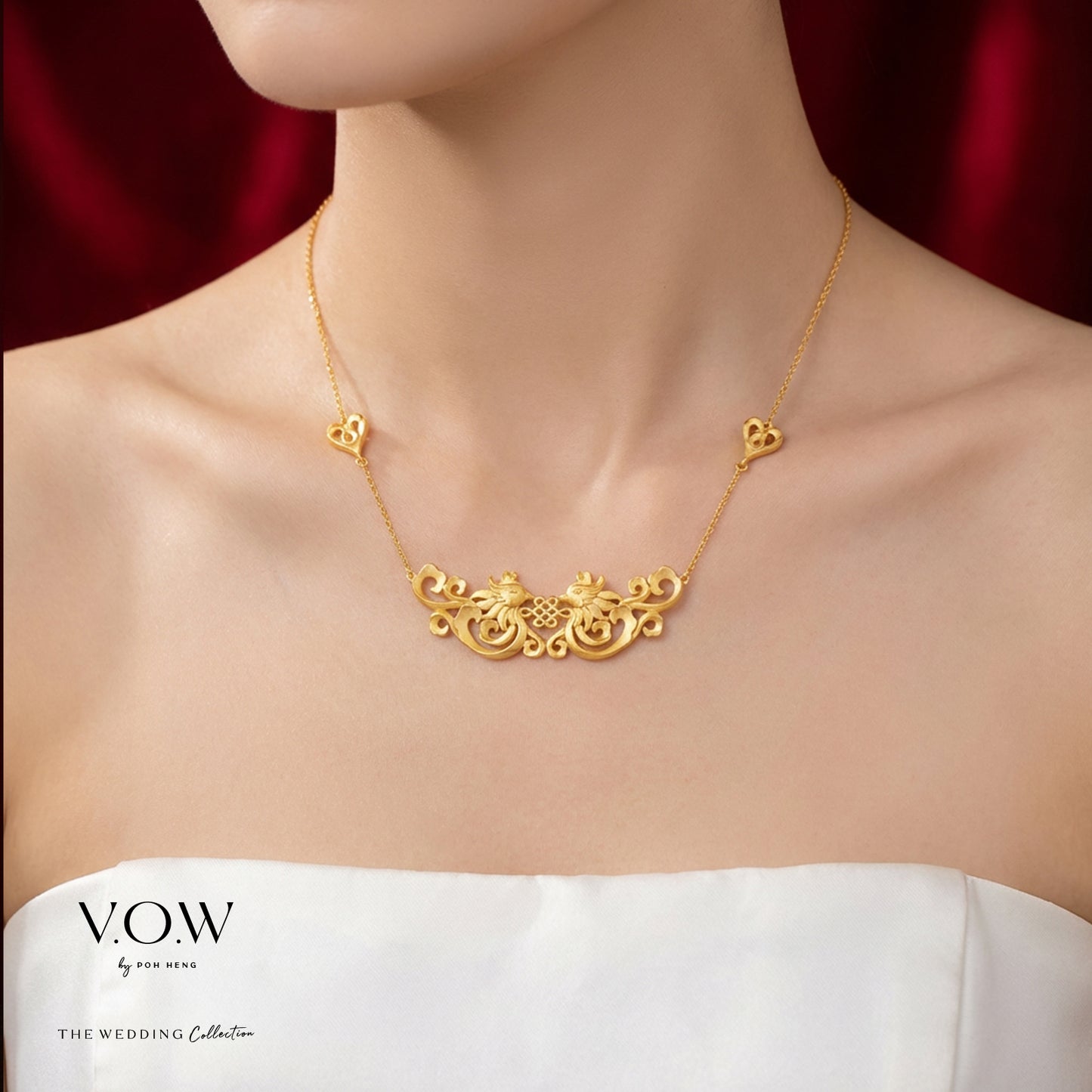 double phoenix necklace in 24k yellow gold with intricate design and heart accents, symbolizing happiness and blessings.