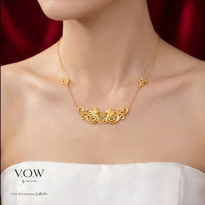 Double Phoenix necklace in 24K yellow gold with intricate design and heart accents, symbolizing happiness and blessings.