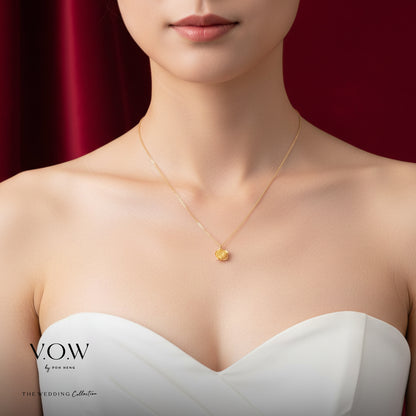 Rose necklace in 24K yellow gold featuring a floral design, elegantly worn on a model’s neck.
