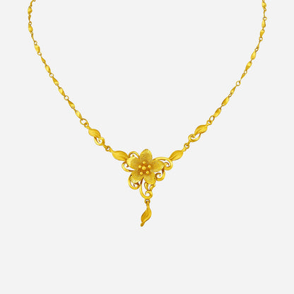 Vibrant Blossom Necklace in 24K yellow gold with floral design and leaf accents, showcasing nature's beauty.