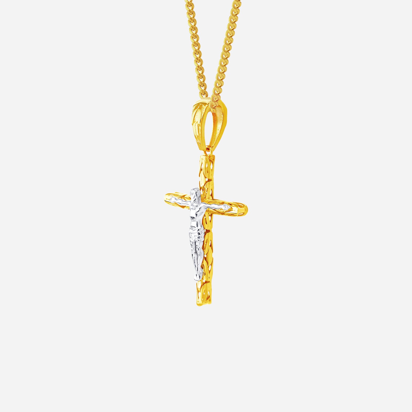 22K yellow and white gold crucifix pendant with a sculpted cross design, featuring contrasting tones and intricate details.