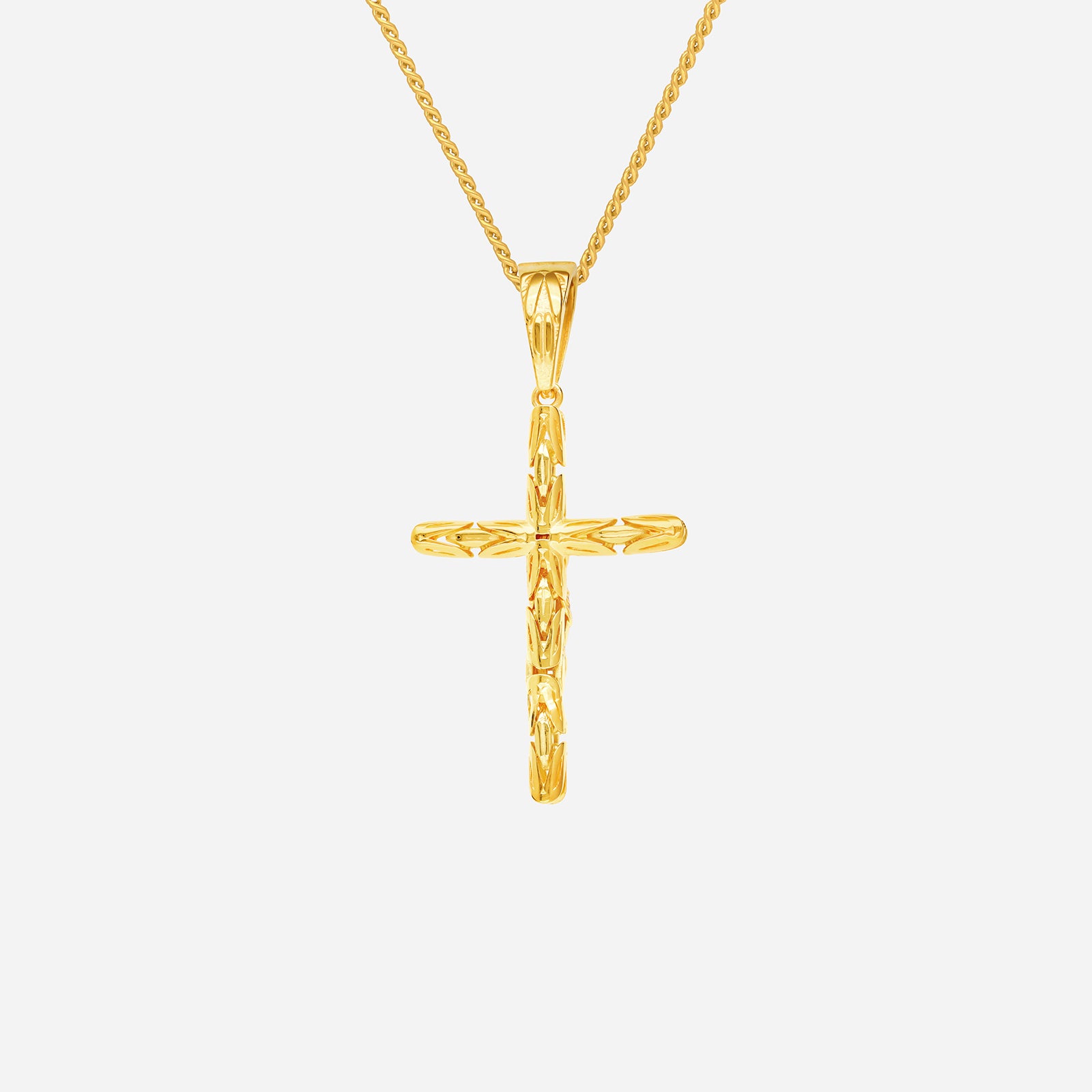 Crucifix pendant in polished 22K yellow gold with sculpted cross design, chain not included.