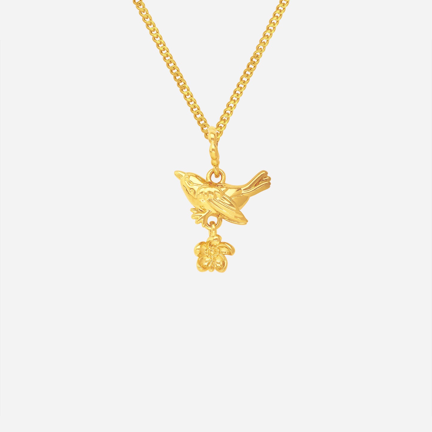 blooming bird pendant in 22k yellow gold featuring a bird and delicate flower design. elegant and whimsical style.