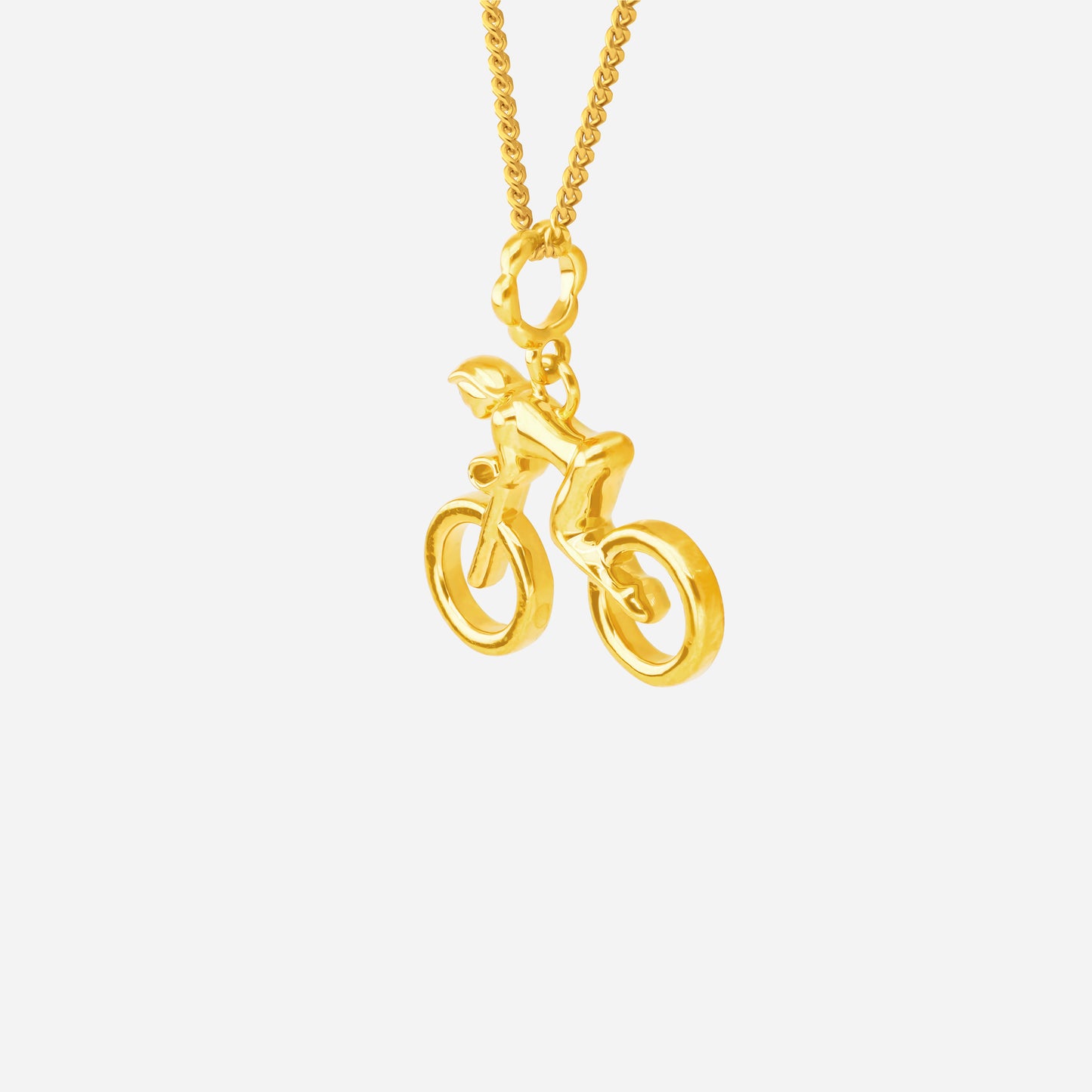 22k yellow gold cycling pendant featuring a sculpted cyclist in motion, symbolizing speed and ambition.