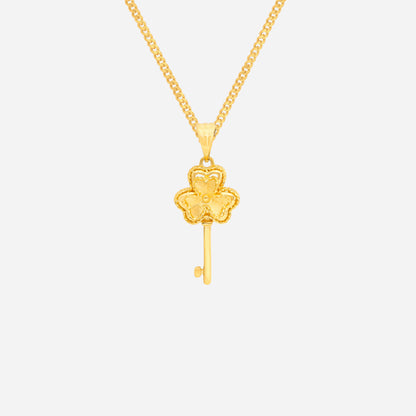 Clover key pendant in 24K yellow gold featuring a four-leaf clover design with a slender key. Elegant jewelry piece.
