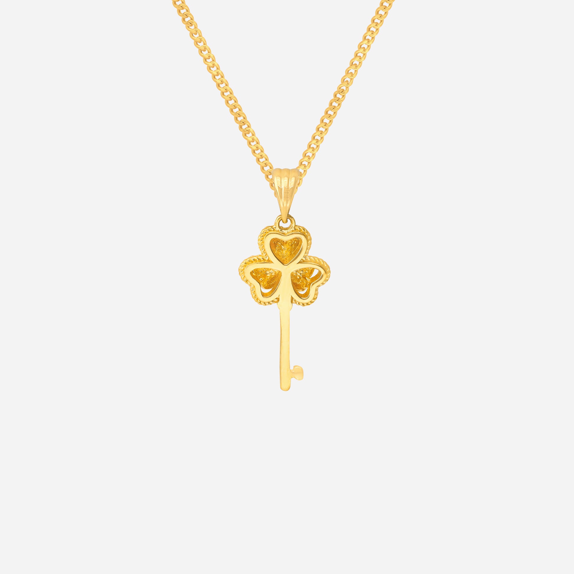 Clover key pendant in 24K yellow gold featuring a four-leaf clover design with a slender key.