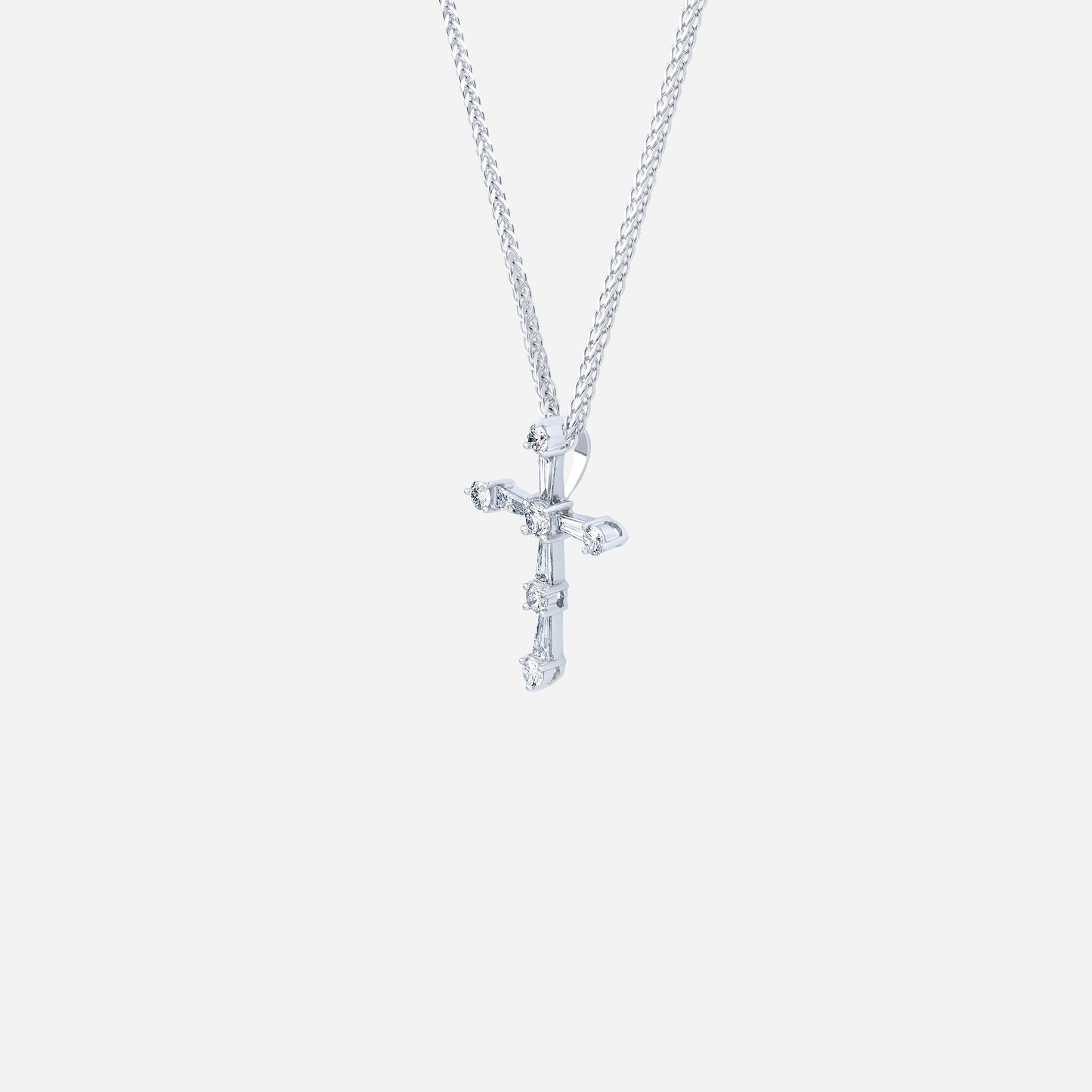 cross pendant in 18k white gold, featuring tapered and round diamonds for a modern, radiant design.