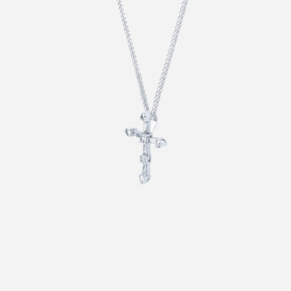 Cross pendant in 18K white gold, featuring tapered and round diamonds for a modern, radiant design.