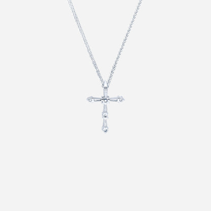 Cross diamond pendant in 18K white gold with tapered and round diamonds, featuring a modern and simple design.