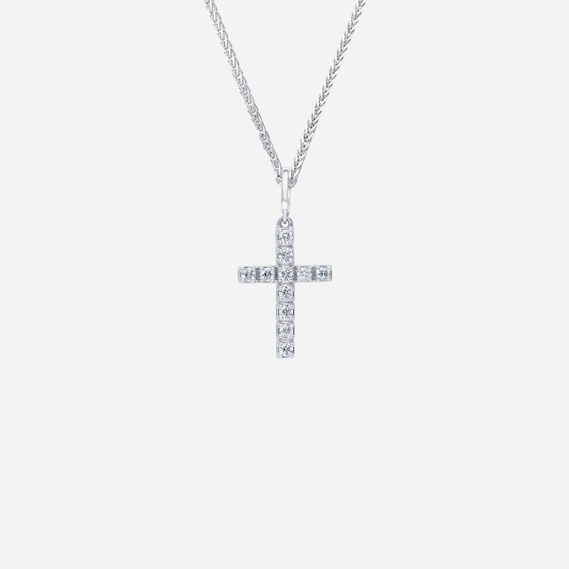 18K white gold cross pendant adorned with sparkling diamonds in a sleek, contemporary design. Chain sold separately.