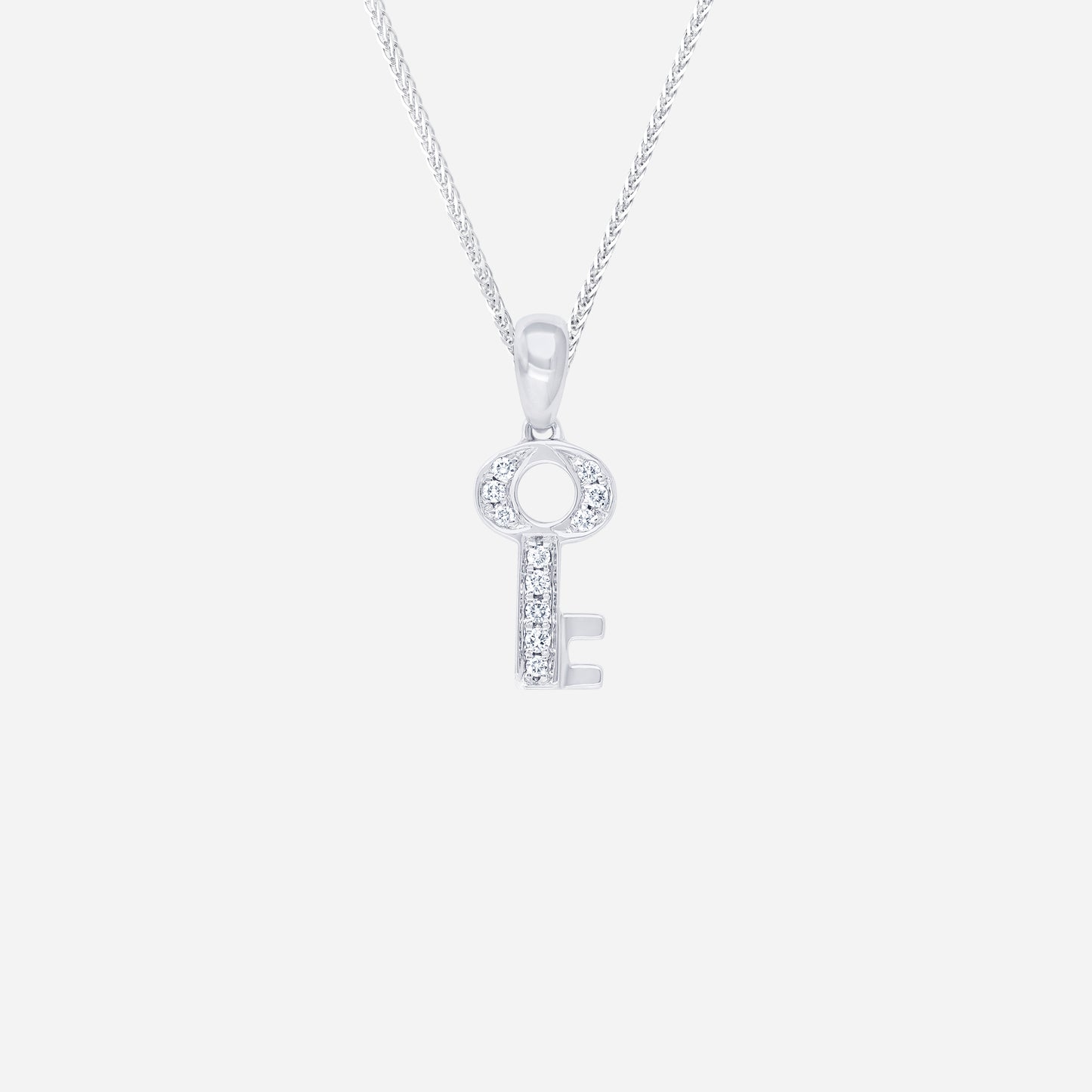 key pendant in 18k white gold adorned with sparkling diamonds, featuring an elegant key design.