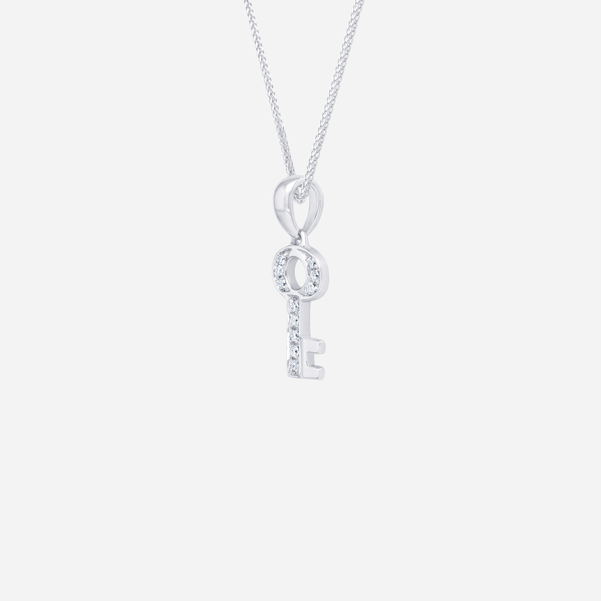 Key pendant in 18K white gold featuring a diamond-studded design, symbolizing dreams and memories.