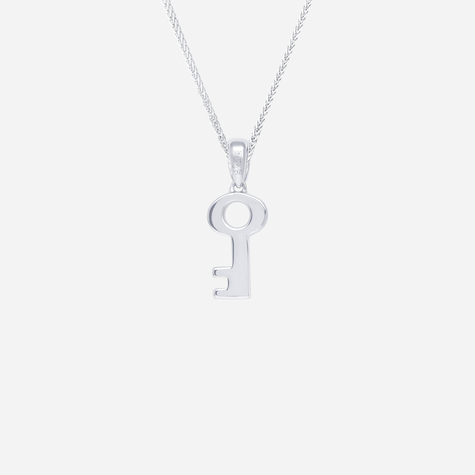 Key pendant in polished 18K white gold, featuring a minimalist key design. Chain sold separately.
