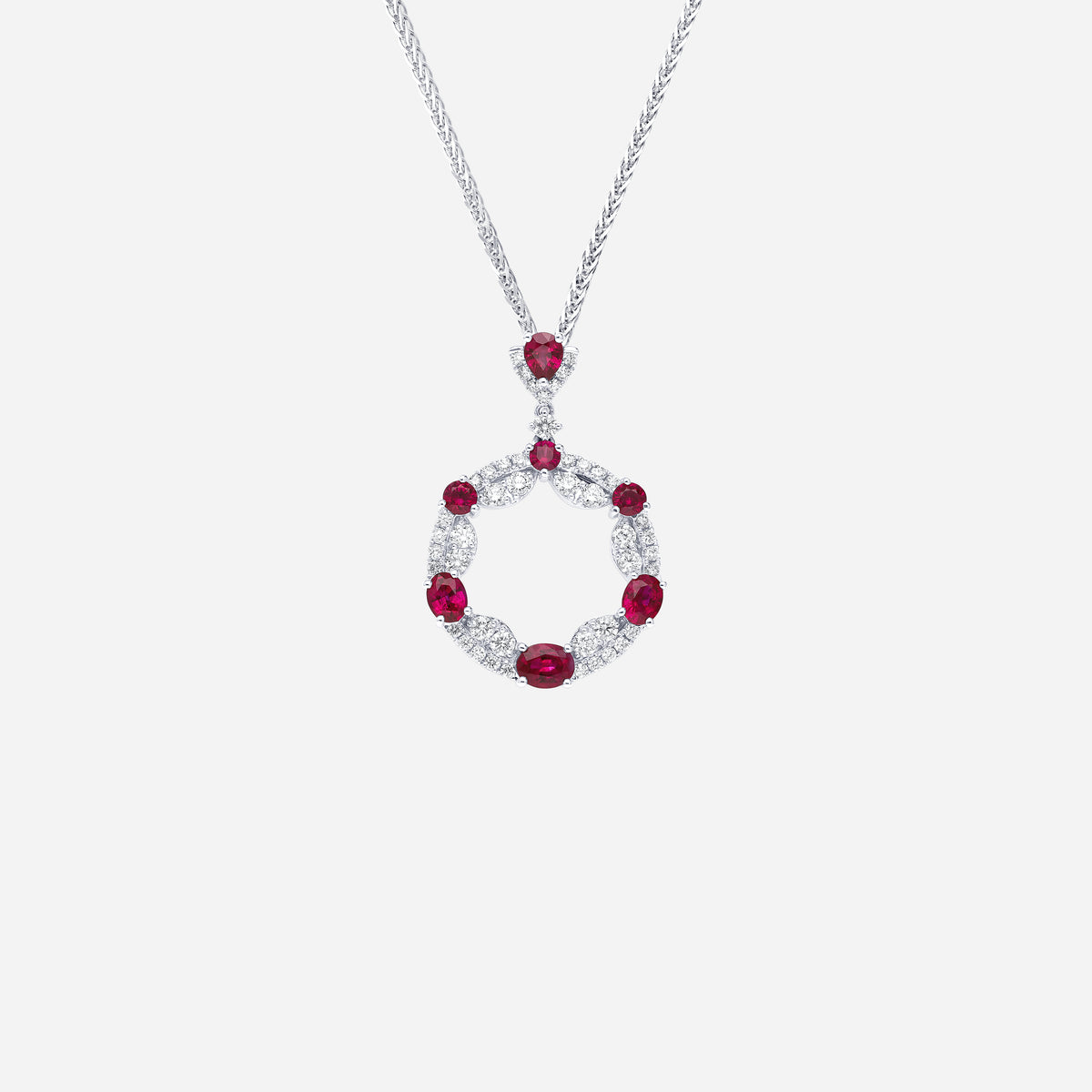 ruby and diamond pendant in 18k white gold with circular openwork design, featuring alternating rubies and diamonds.