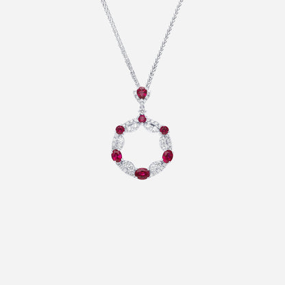Ruby and diamond pendant in 18K white gold with circular openwork design, featuring alternating rubies and diamonds.
