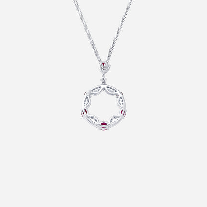 Ruby and diamond pendant in 18K white gold with circular openwork design and alternating rubies and diamonds.
