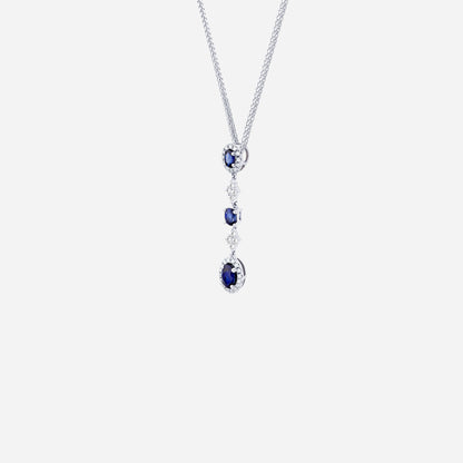 Blue sapphire and diamond pendant in 18K white gold with oval sapphires and diamond halos, showcasing fluid design.