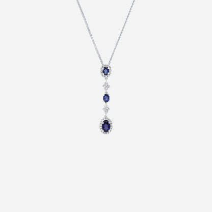 Blue sapphire and diamond pendant in 18K white gold with oval sapphires and diamond halos for elegant fluid movement.