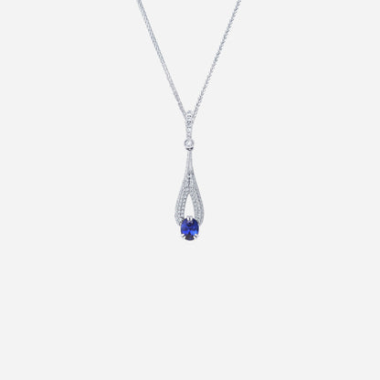 Blue sapphire pendant in 18K white gold, surrounded by pavé-set diamonds in elegant elongated design.