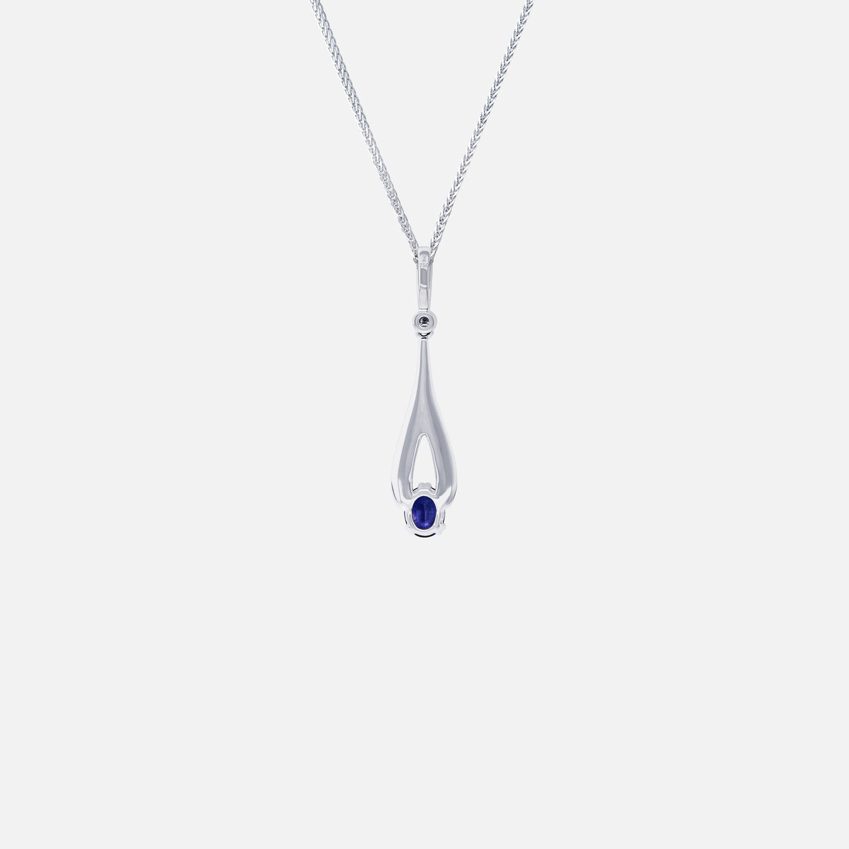 Blue sapphire pendant in elegant white gold setting with diamond accents, featuring an elongated silhouette.