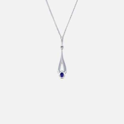Blue sapphire pendant in elegant white gold setting with diamond accents, featuring an elongated silhouette.