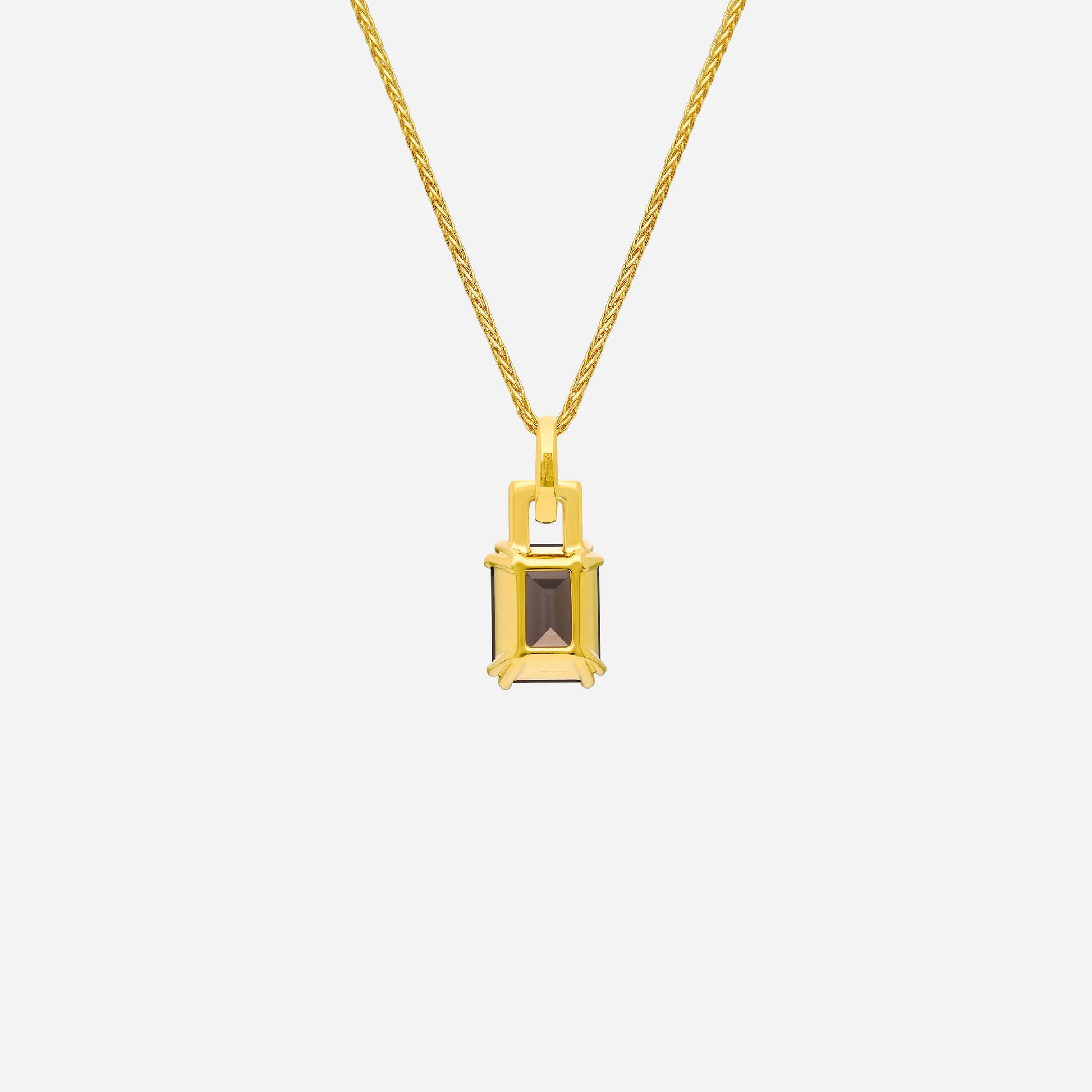 Luxe pendant featuring a smoky quartz gemstone and diamond accents set in 18K yellow gold. Elegant and refined design.