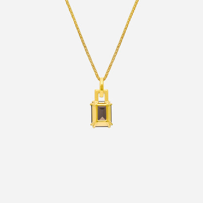 Luxe pendant featuring a smoky quartz gemstone and diamond accents set in 18K yellow gold. Elegant and refined design.