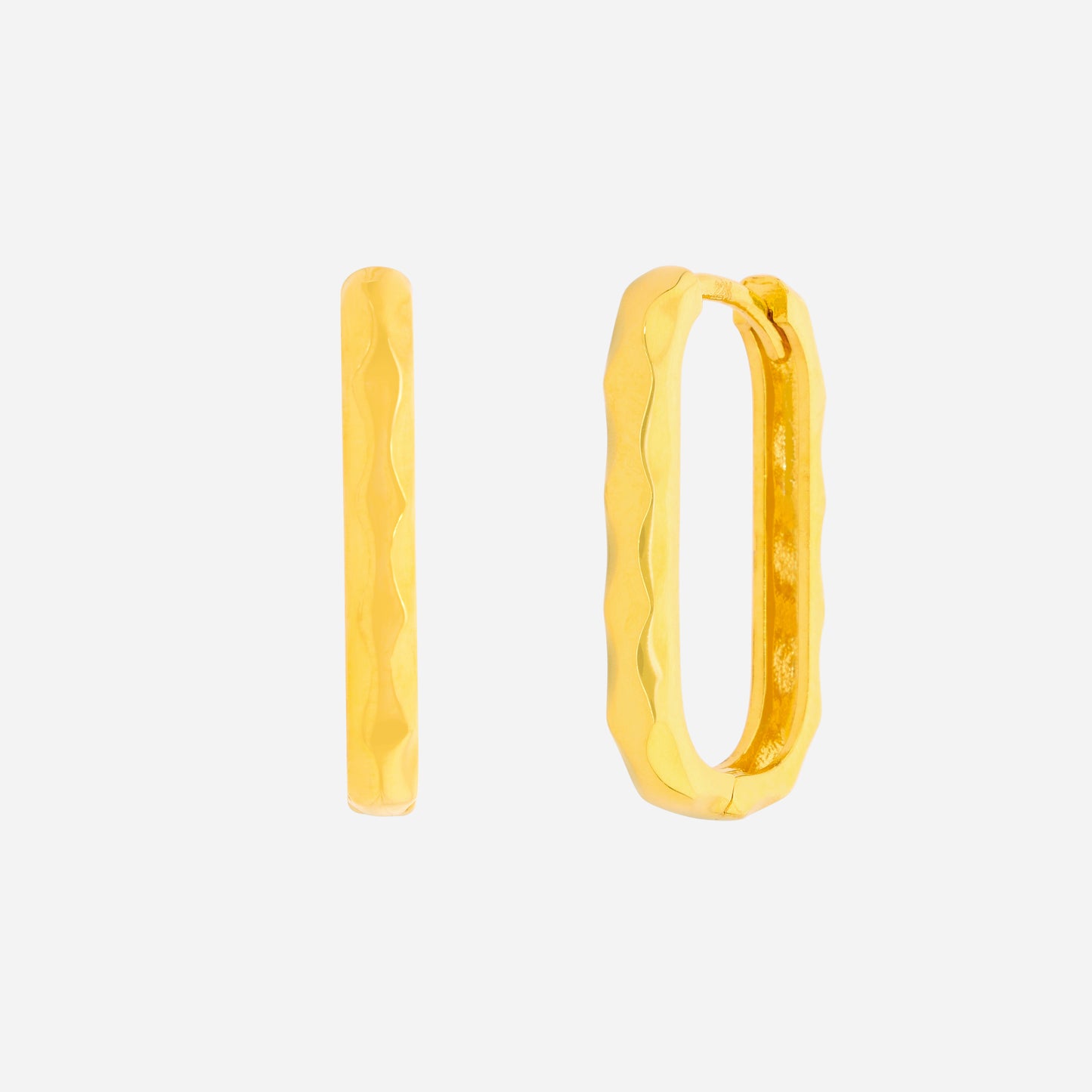 curved huggie earrings in 22k yellow gold with a soft textured design, showcasing a minimal and fluid aesthetic.