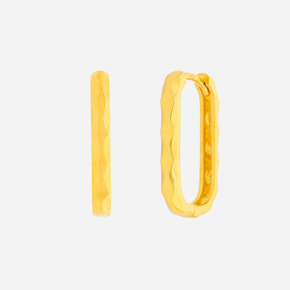 Curved huggie earrings in 22K yellow gold with a soft textured design, showcasing a minimal and fluid aesthetic.