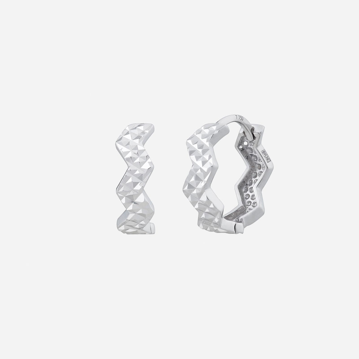 18k white gold earrings with a modern zigzag design and faceted surface, showcasing unique style and elegance.