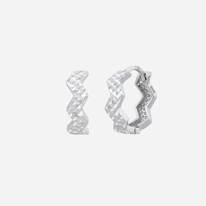 18K White Gold earrings with a modern zigzag design and faceted surface, showcasing unique style and elegance.