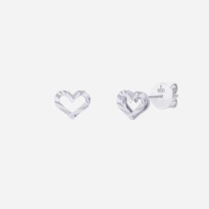 Heart earrings in 18K white gold with a modern cut-out design, reflecting a timeless love motif.