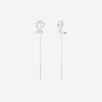Linear shimmer diamond earrings in 18K white gold with spiral design and slender threader chains, featuring diamond accents.