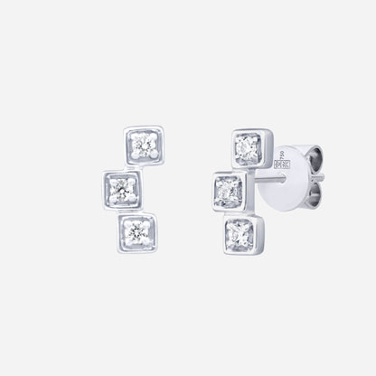 Delicate cube diamond earrings in 18K white gold with three diamonds in modern geometric design.