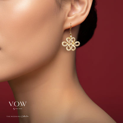 Eternity Knot diamond dangling earrings in 18K yellow gold with a delicate openwork design.