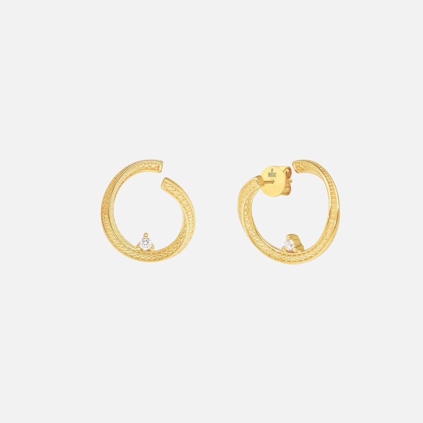 curved hoop earrings in 18k yellow gold, featuring a single diamond and fine textural detailing for a delicate glimmer.
