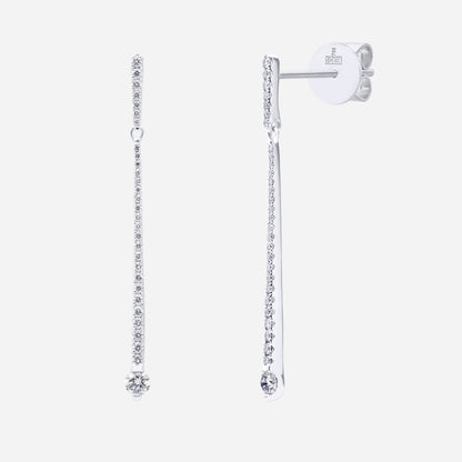 Elongated diamond earrings in 18K white gold with sparkling gemstones, featuring a vertical line design.