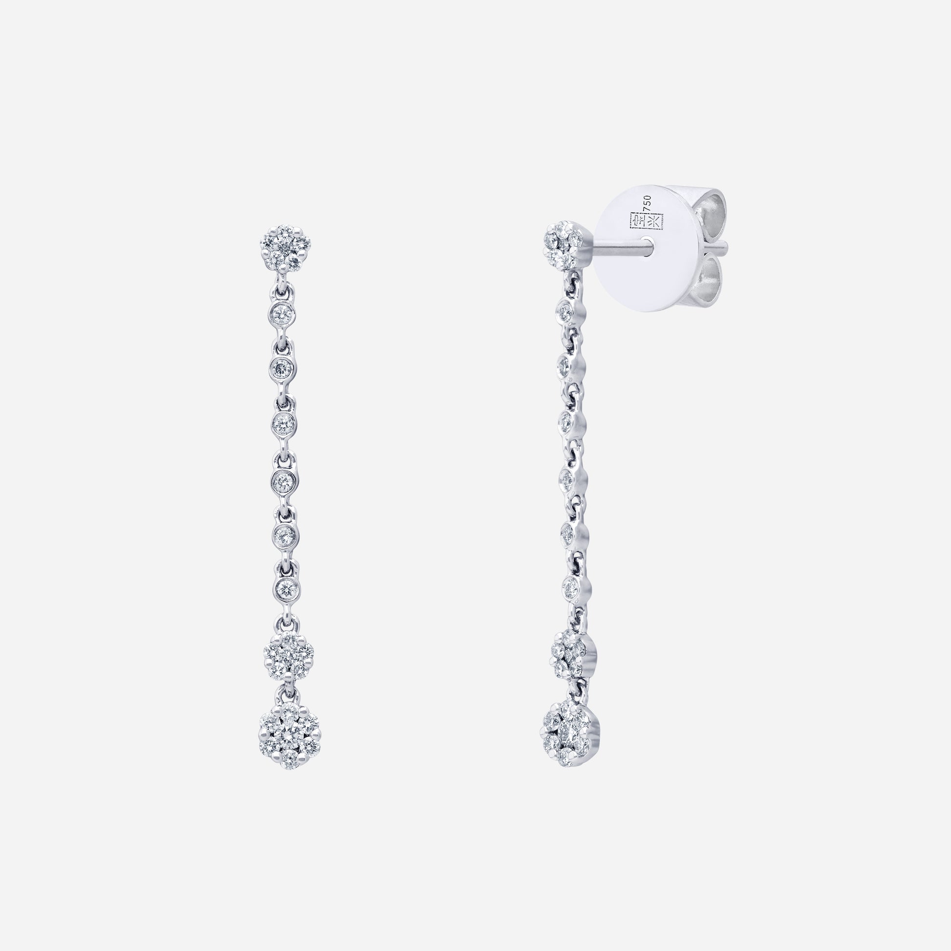 Chandelier diamond earrings in 18K white gold with cascading clusters and floral-inspired design.
