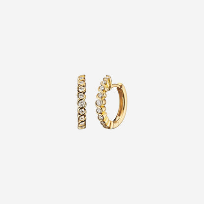 Love Journey swirl earrings in 18K yellow gold with a circle of diamonds, featuring a coiled design.